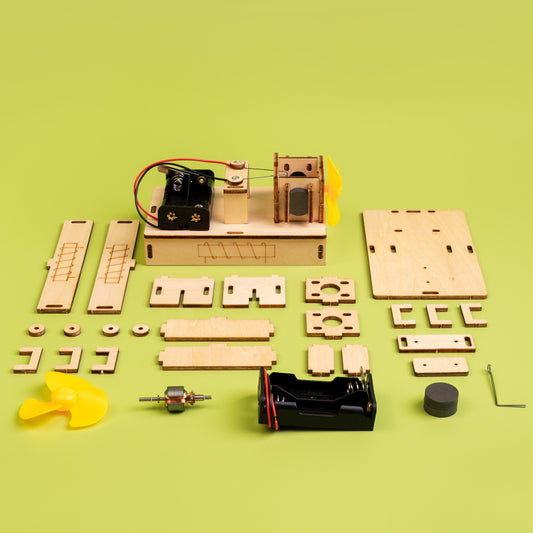 Wooden mechanical model kit on a green background