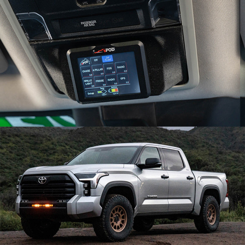 Close-up of a car dashboard with a GPS device and a Toyota truck parked outdoors.