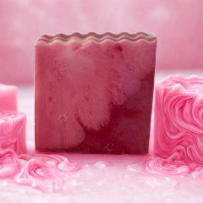 Pink soap bar with a wavy texture on a pink background