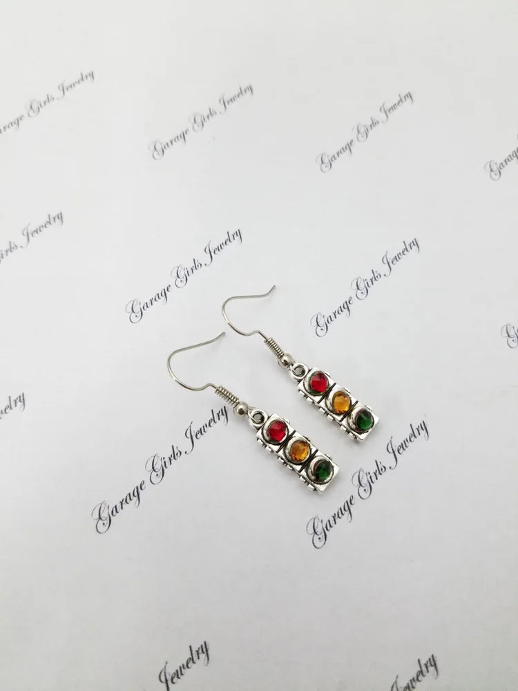 Pair of earrings with colorful stones on a branded card. Stoplight Dangle Earrings