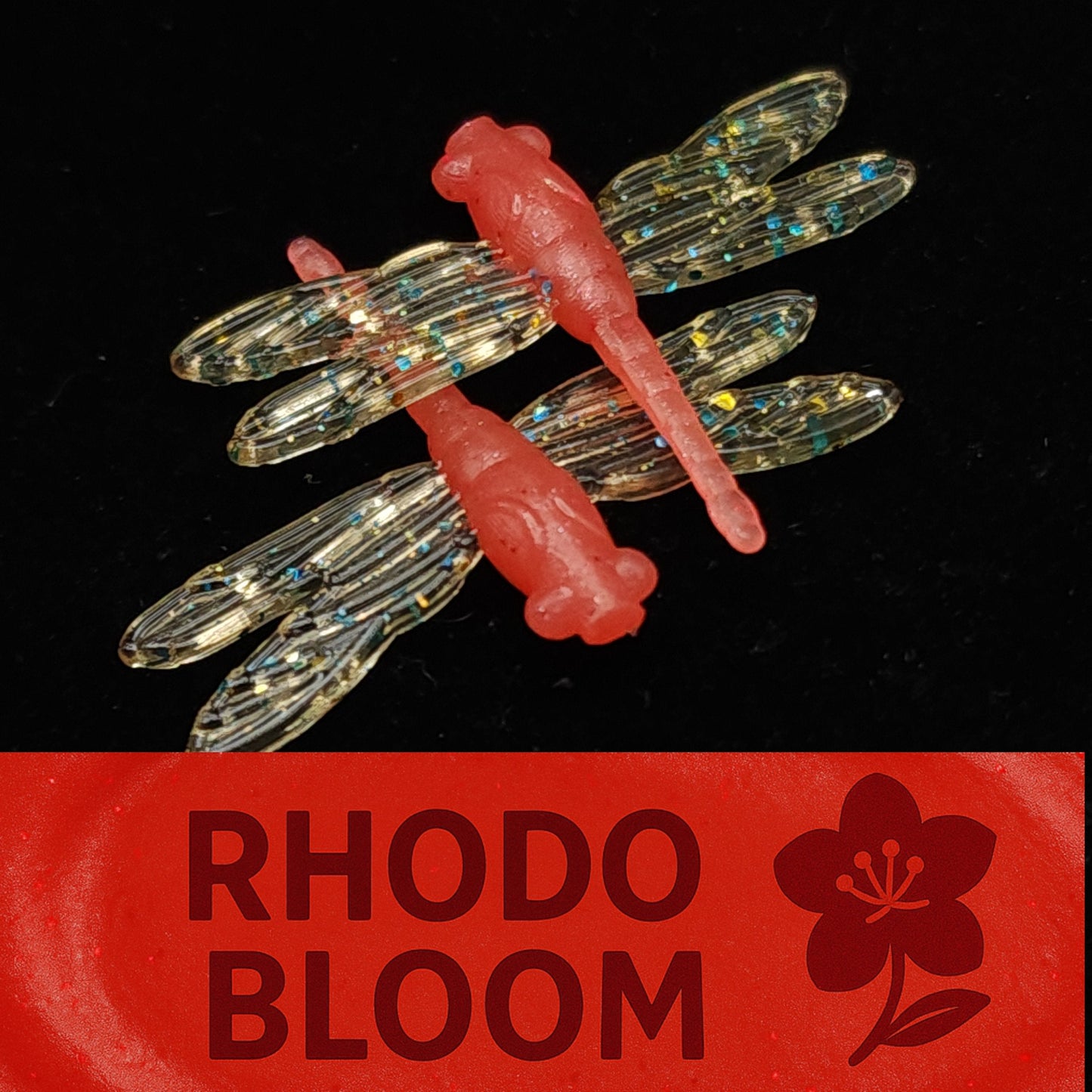 Dragonfly-shaped fishing lure with clear wings and red body on a black background, branded 'Rhodo Bloom'.