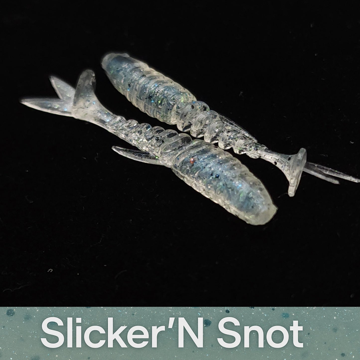 Two blue fishing lures labeled 'Slicker'N Snot' on a black background