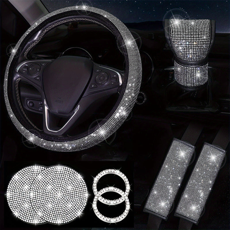 Car interior accessories set with bling, including steering wheel cover, seat belt covers, and coasters.
