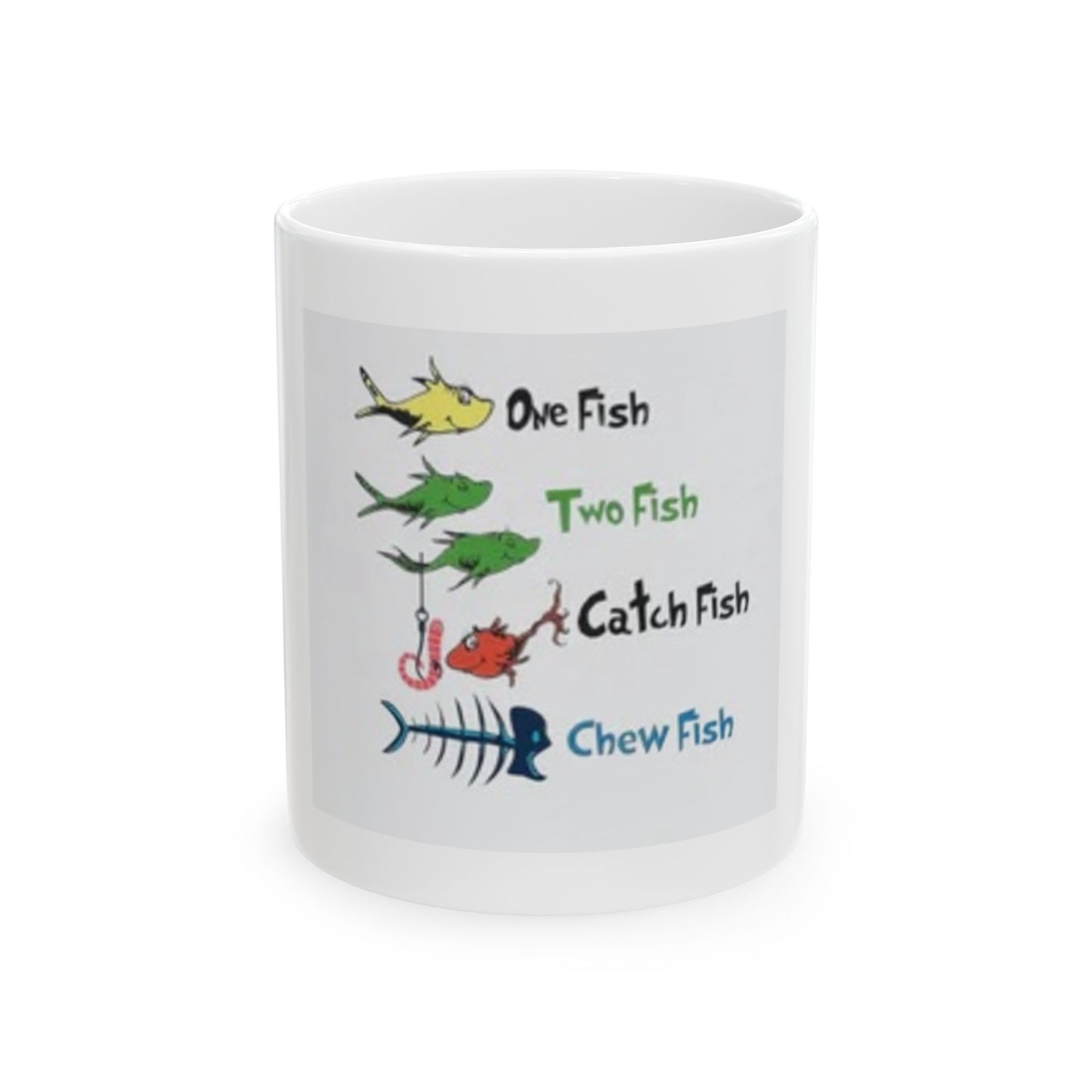 A white ceramic mug with colorful text and fish illustrations, spoofing the 'One Fish Two Fish' theme from Dr. Seuss.