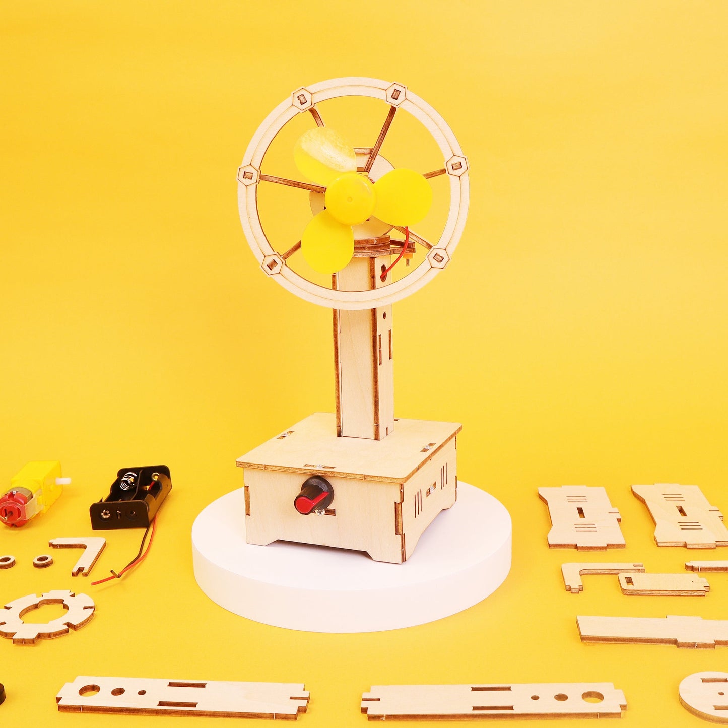 Wooden mechanical model with yellow propeller on a yellow background