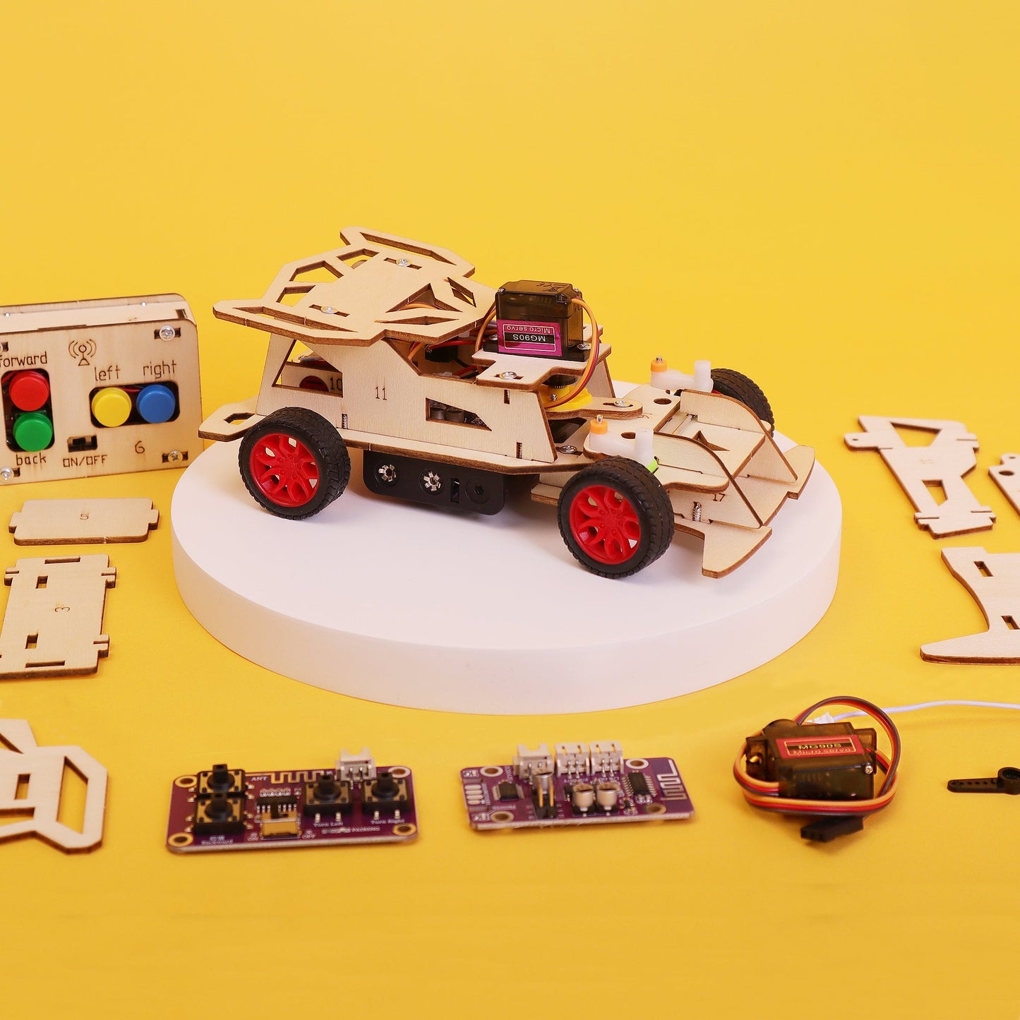Wooden robot car kit with electronic components on a yellow background