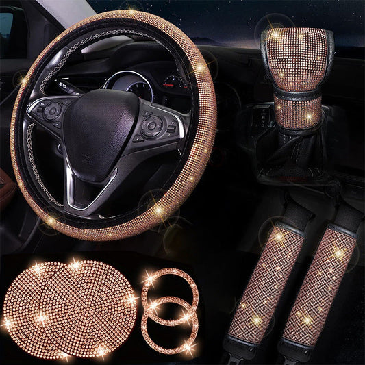 Car interior accessories set with bling, including steering wheel cover, gear shift cover, and cup holder covers.