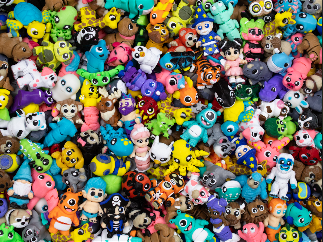 Collection of colorful small figurines in various shapes and colors.