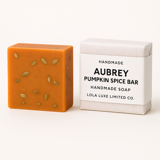 Aubrey Pumpkin Spice Bar. Orange handmade soap bar with pumpkin spice scent next to its packaging on a white background