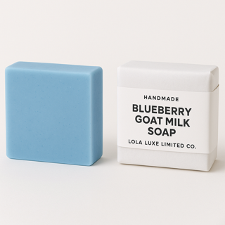 Blueberry Goat Milk bar of soap next to its packaging on a white background