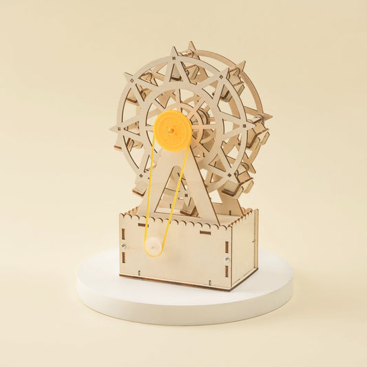 Wooden mechanical model of a Ferris wheel on a beige background