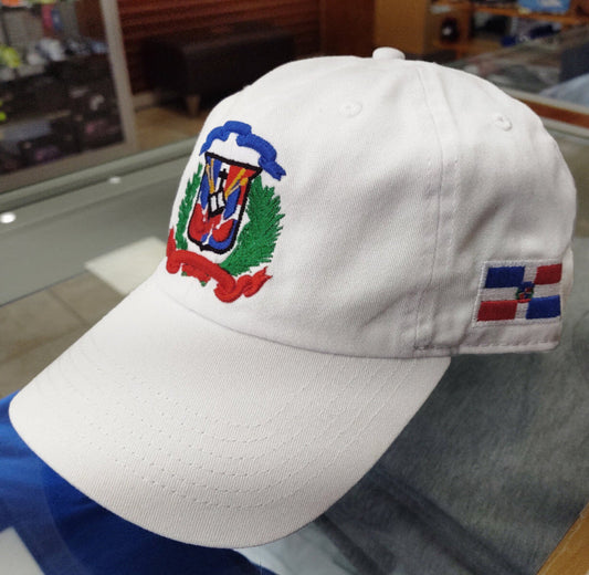 White cap with embroidered Dominican design on a glass surface