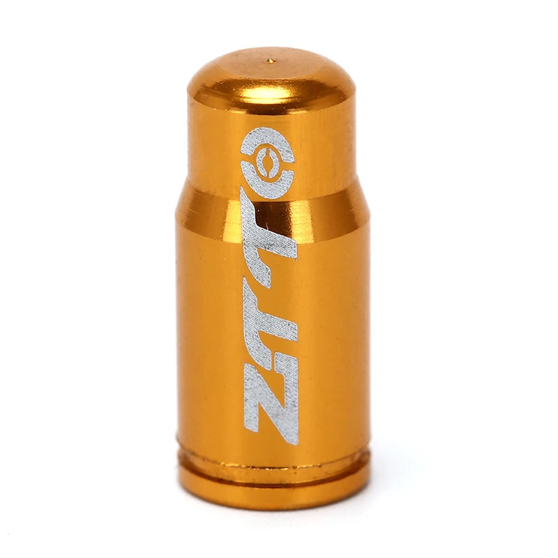 Gold cylindrical valve cover with 'Zeta' branding on a white background
