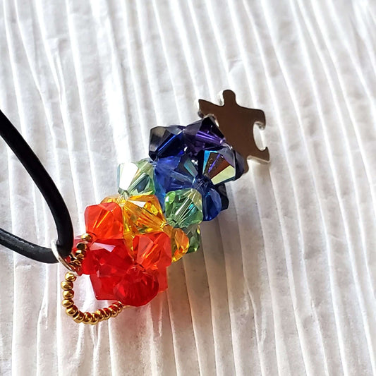 Colorful necklace tie with a metal clasp on a white fabric background