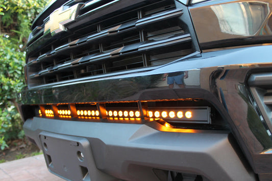 Close-up of a vehicle's front grille with LED lights on a blurred background