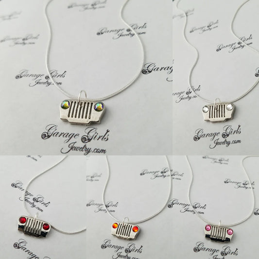 Necklaces with car grille charms on a 'Garage Girls Jewelry' branded card.