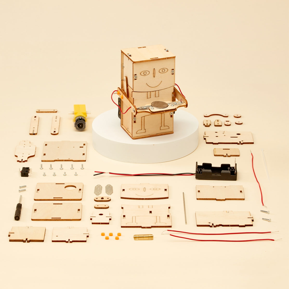 Wooden robot kit with components on a beige background