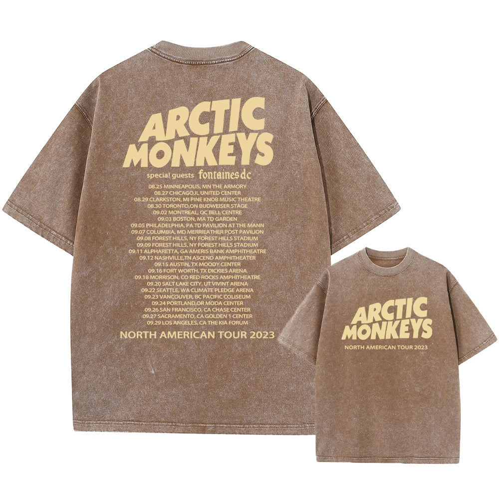 Brown t-shirt with 'Arctic Monkeys' text and tour information on a white background