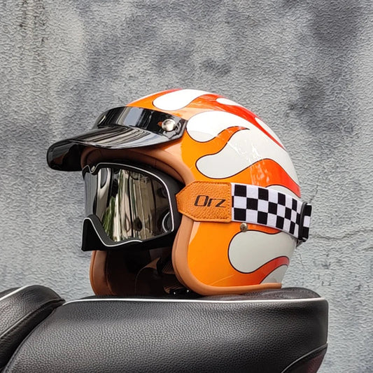 Orange and white helmet with a checkered strap on a gray textured background