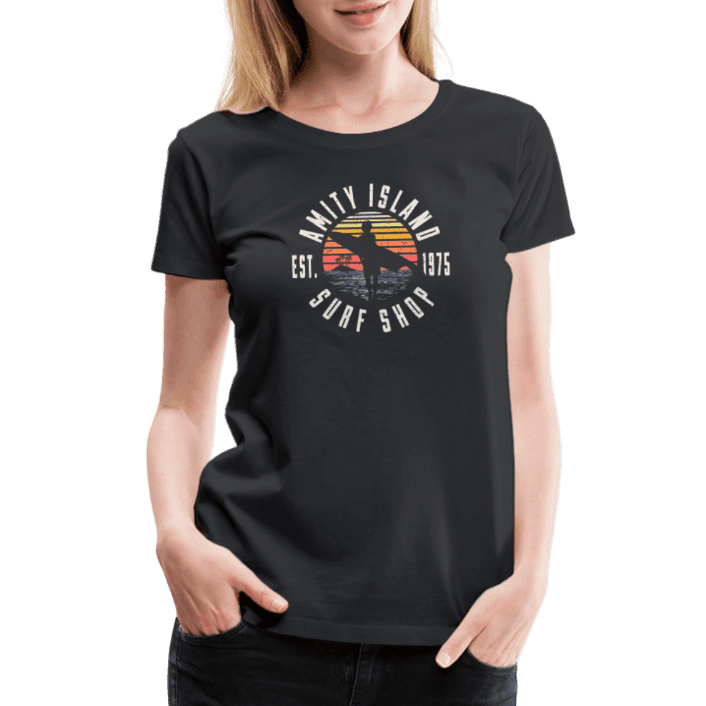 Person wearing a black t-shirt with a 'Surf Shop' graphic design.