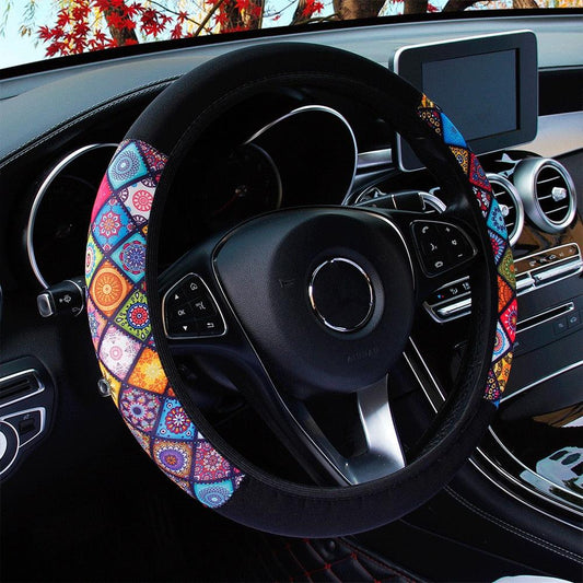Colorful steering wheel cover on a car steering wheel with a blurred outdoor background