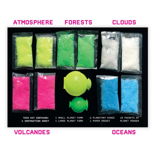 Science kit with colored powders labeled 'Atmosphere', 'Forests', 'Clouds', 'Volcanoes', and 'Oceans' on a white background.