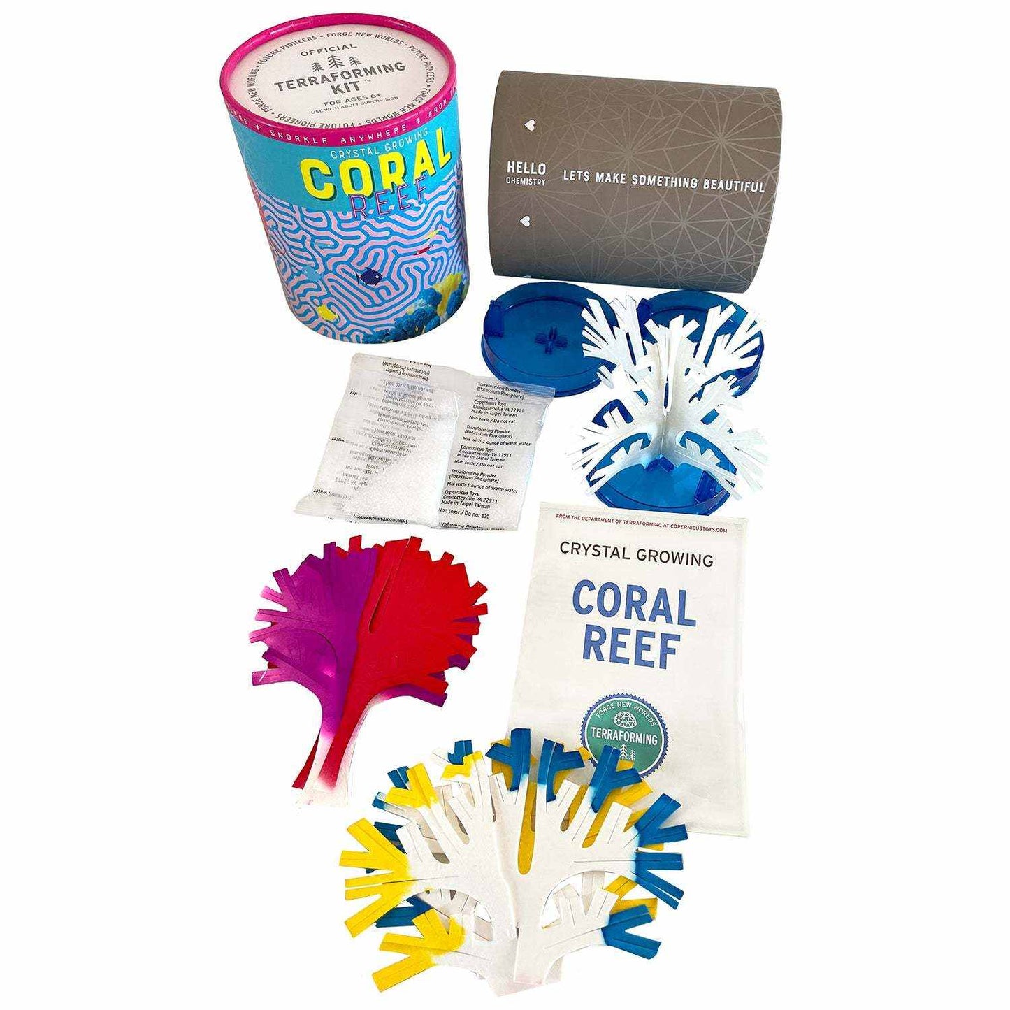 Coral reef crystal growing kit with colorful components on a white background