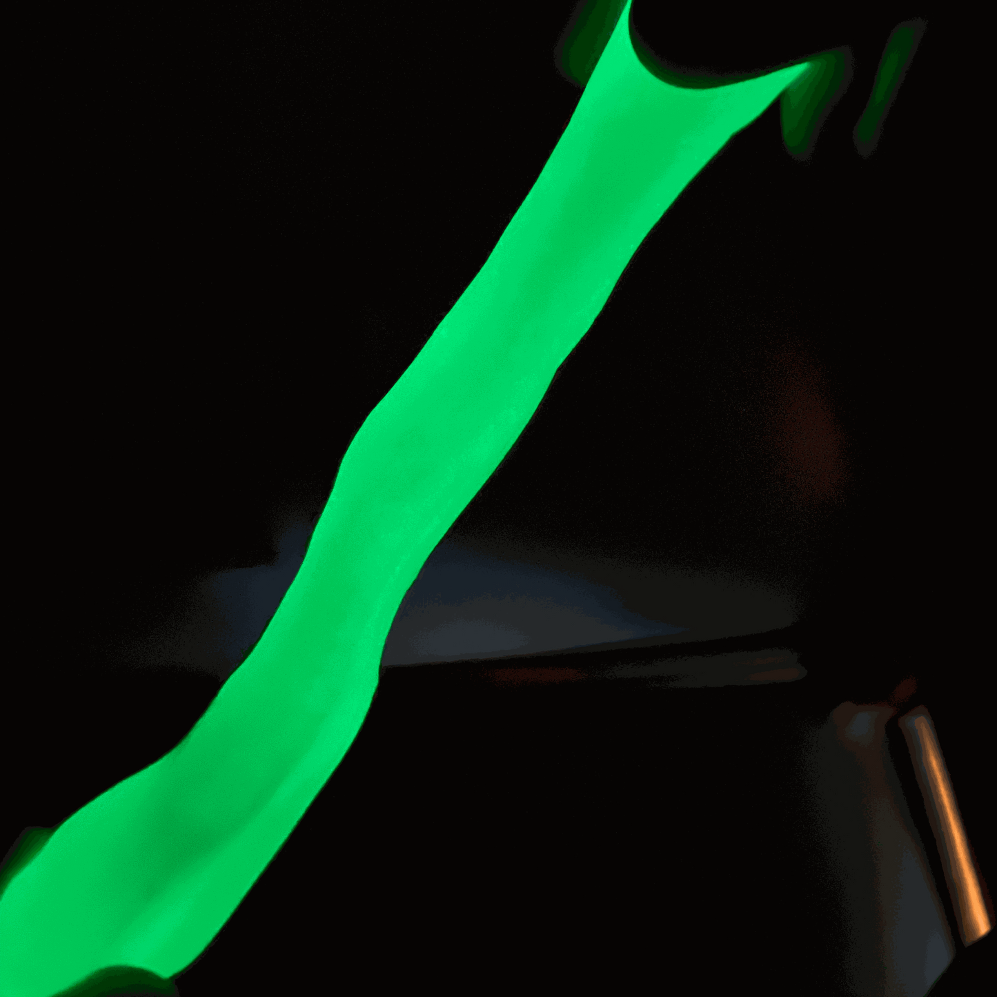 Glowing green gootonium stretched in the dark
