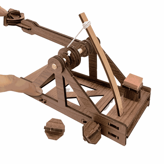Wooden model of a trebuchet on a white background