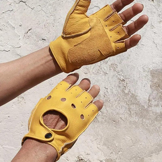 Yellow leather gloves with fingerless design on a textured surface