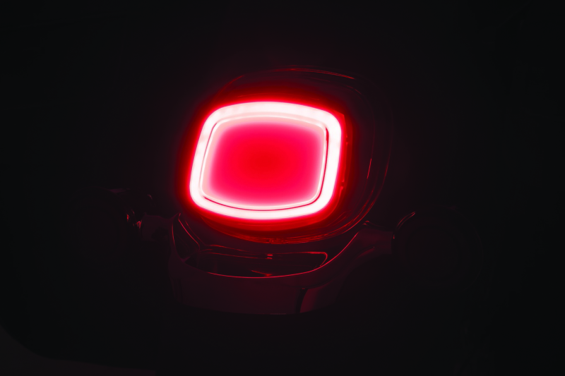 Illuminated Motorcycle Tail Light on a black background