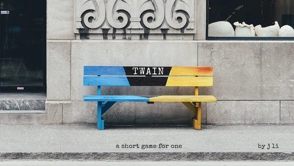 Colorful bench with 'TWAIN' branding against a stone building.