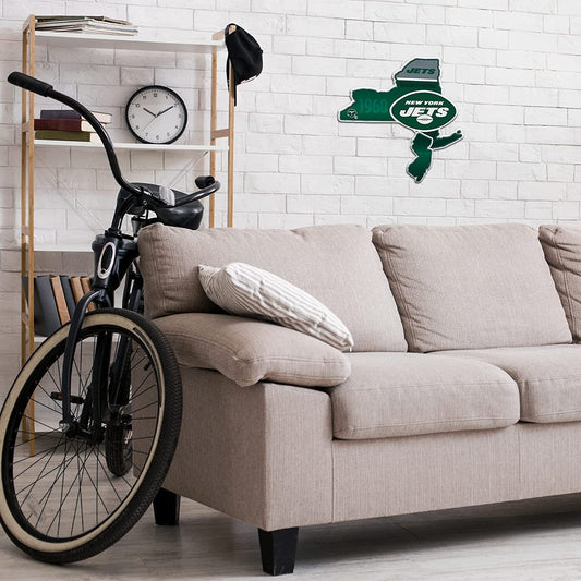 Living room with a beige sofa, bicycle, and New York Jets wall decal.