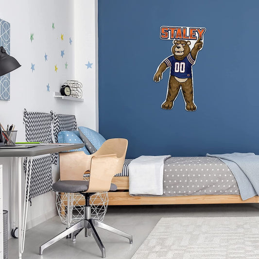 Bedroom with a desk, chair, and bed, featuring a 'Staley' bear mascot on the wall.