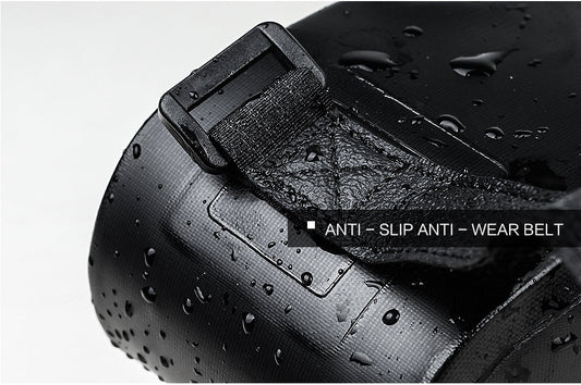 Close-up of a black bicycle bag with anti-slip and anti-wear belt feature, showing water droplets on the surface.