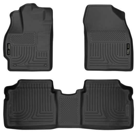 Set of four black car floor mats on a white background