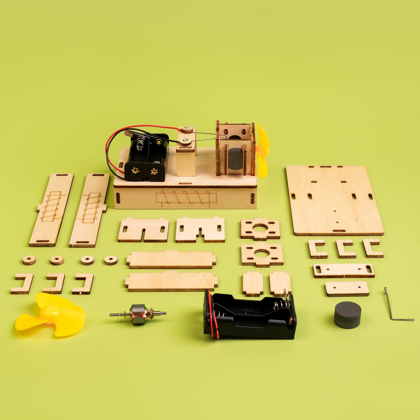 Wooden mechanical model kit on a green background