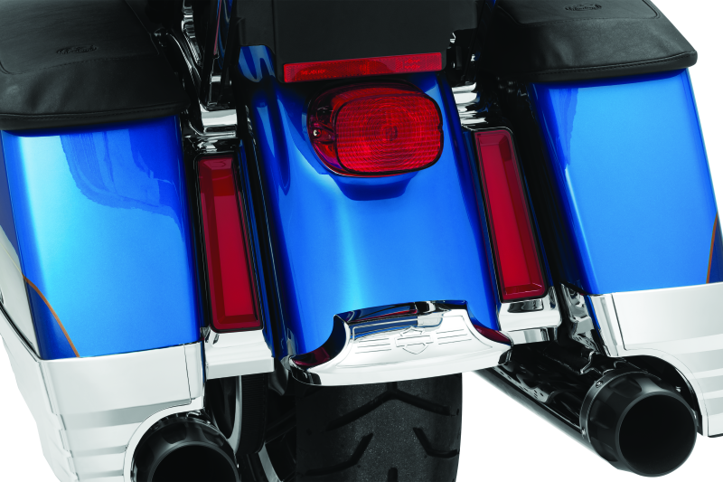 Close-up of a motorcycle's exhaust system with blue and chrome finish.