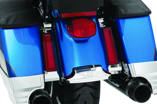 Close-up of a motorcycle's exhaust system with blue and chrome finish.