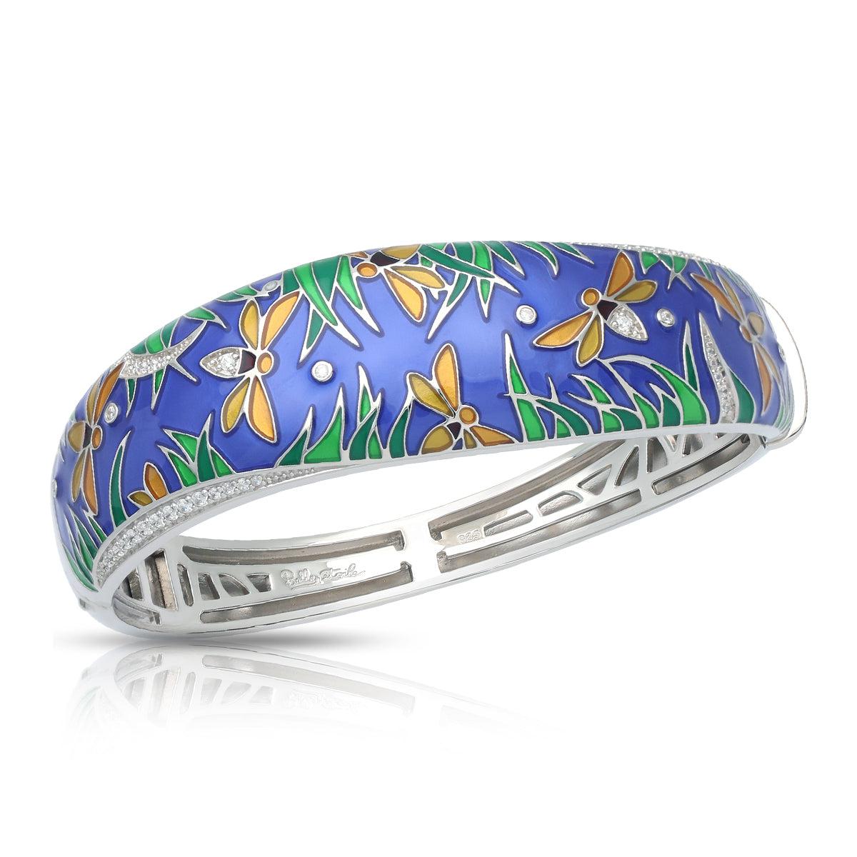 Decorative bracelet with floral and dragonfly design on a white background