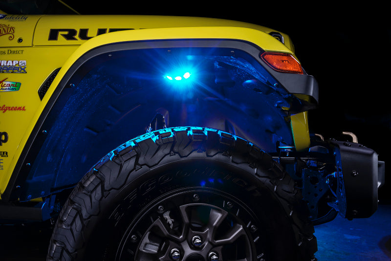 Close-up of a yellow off-road vehicle with blue LED lights on a dark background