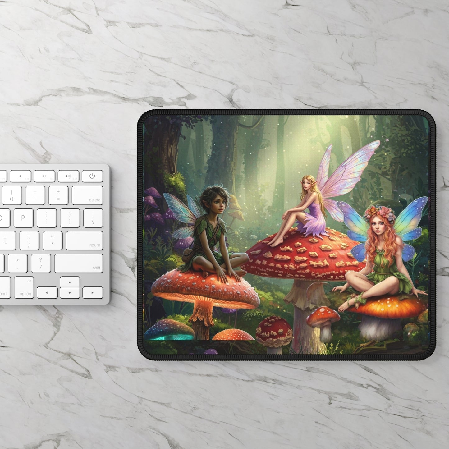 Mouse pad with fairy design on a marble surface with a keyboard.