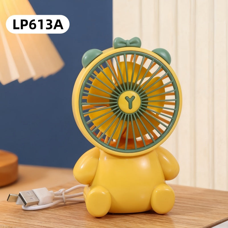 Yellow cartoon-style fan with a USB cable on a wooden surface