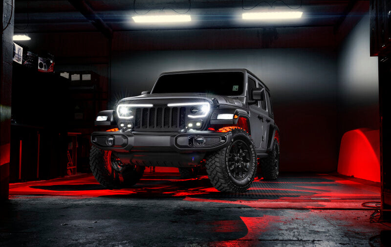 Jeep Wrangler in a dark garage with red underbody lighting