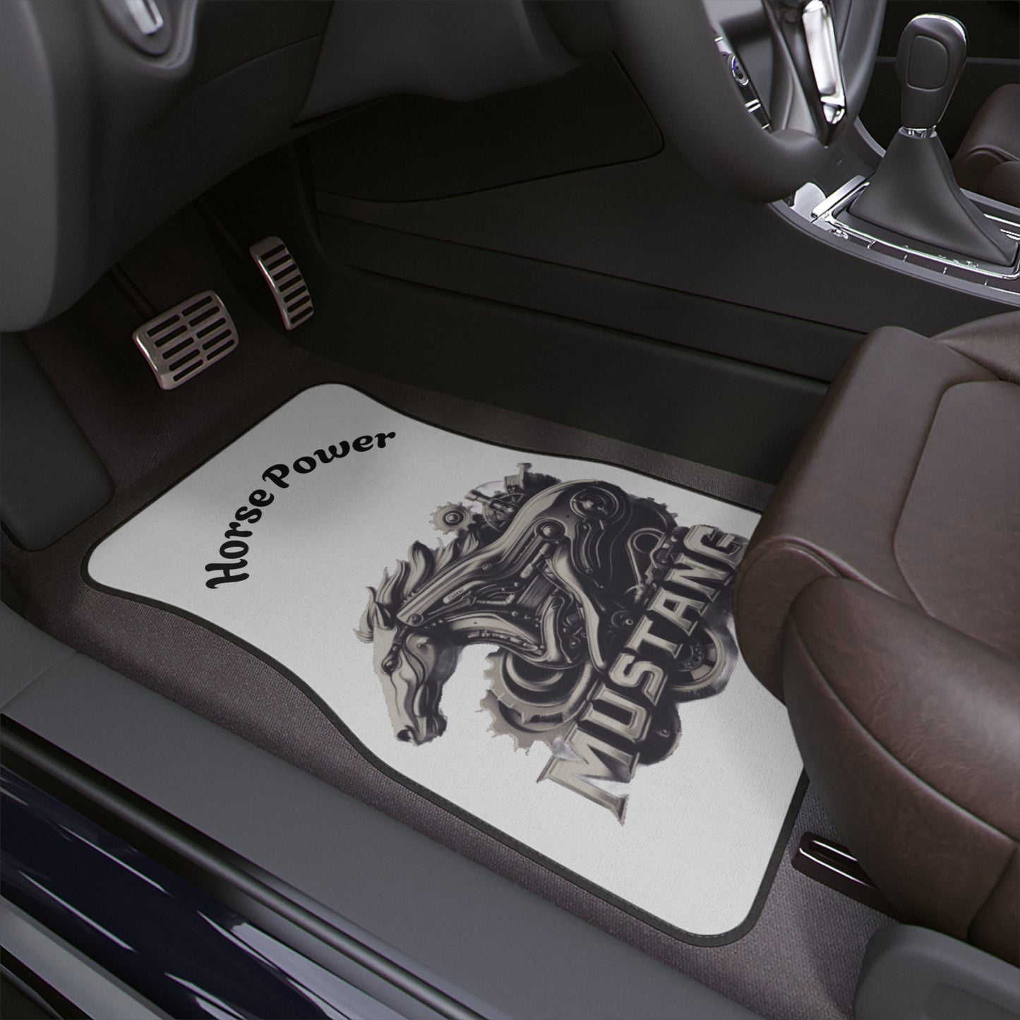 A car floor mat installed in a vehicle interior. The mats are white with a black graphic of a mustang horse and the words 'Horse Power' and 'MUSTANG'.