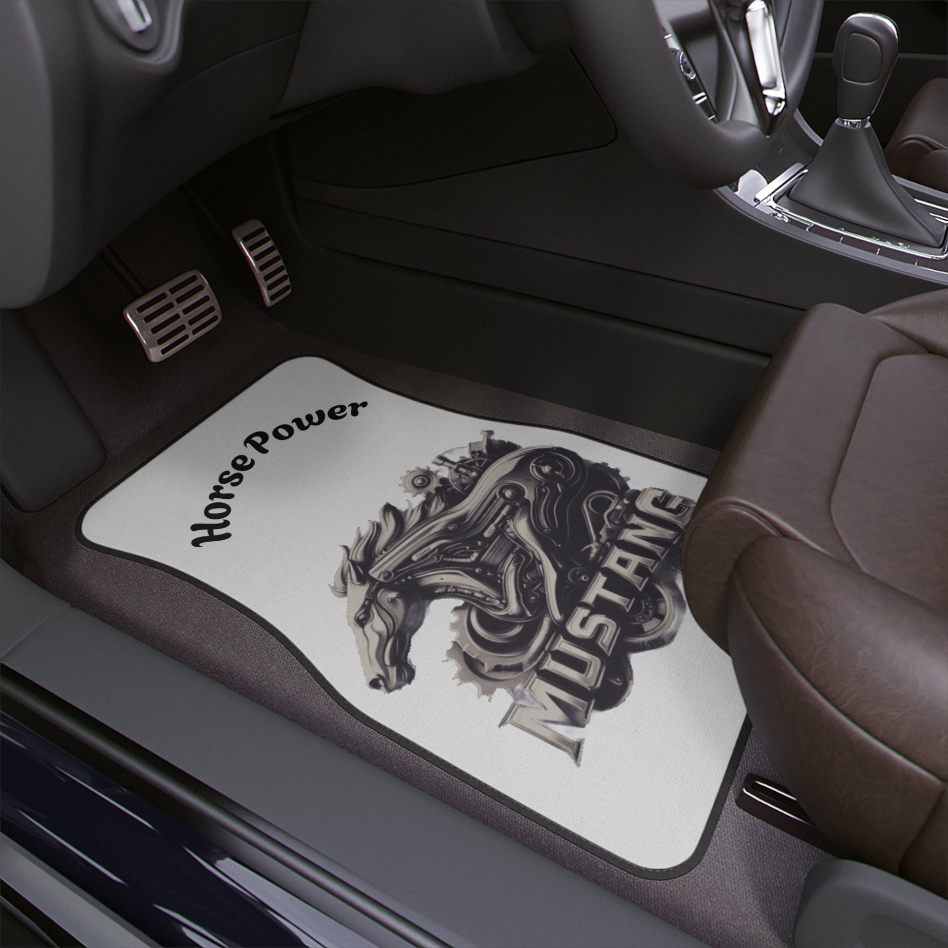 A car floor mat installed in a vehicle interior. The mats are white with a black graphic of a mustang horse and the words 'Horse Power' and 'MUSTANG'.