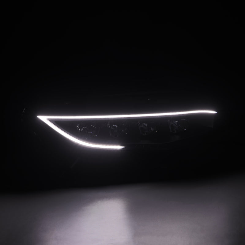 Car headlight with illuminated LED strip on a dark background