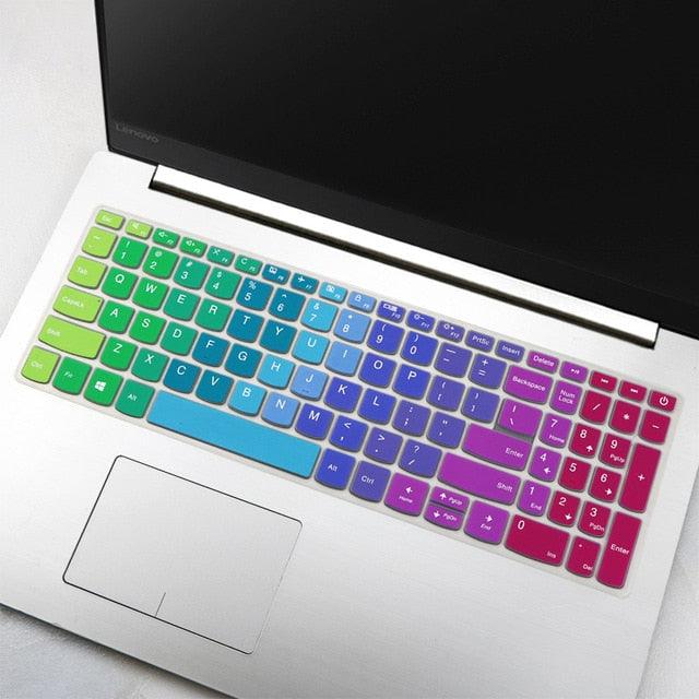 Laptop with a colorful keyboard cover on a white surface