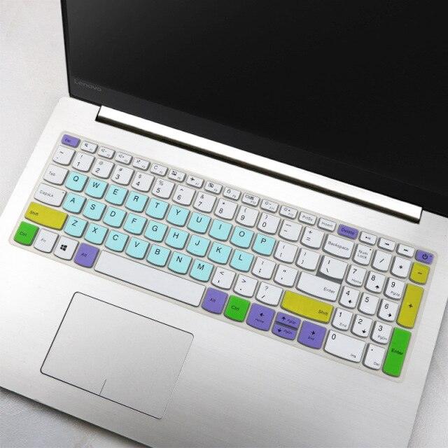 Laptop with a colorful keyboard cover on a light surface