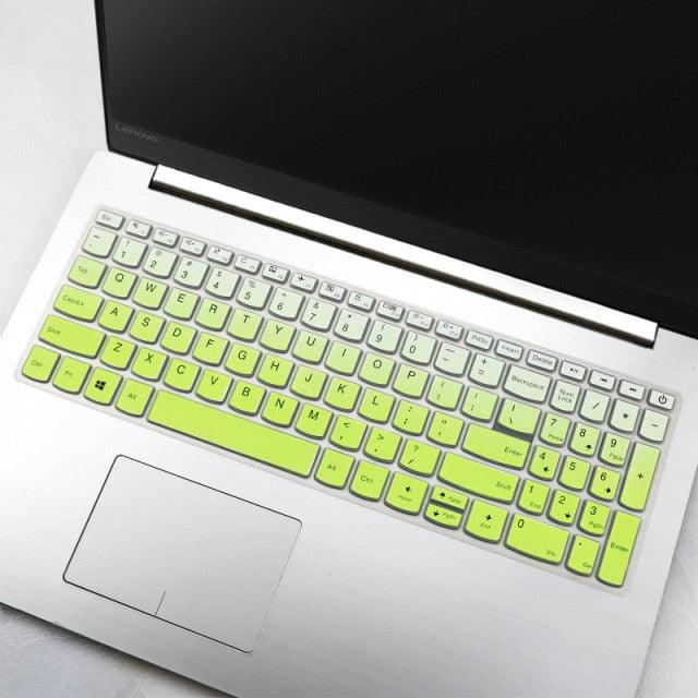 Laptop with a green keyboard cover on a light gray surface